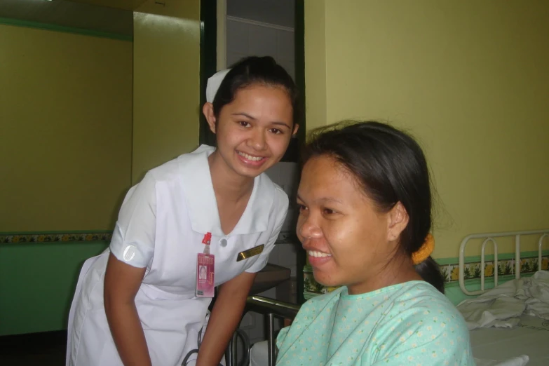 a woman in a white top and another woman smiling
