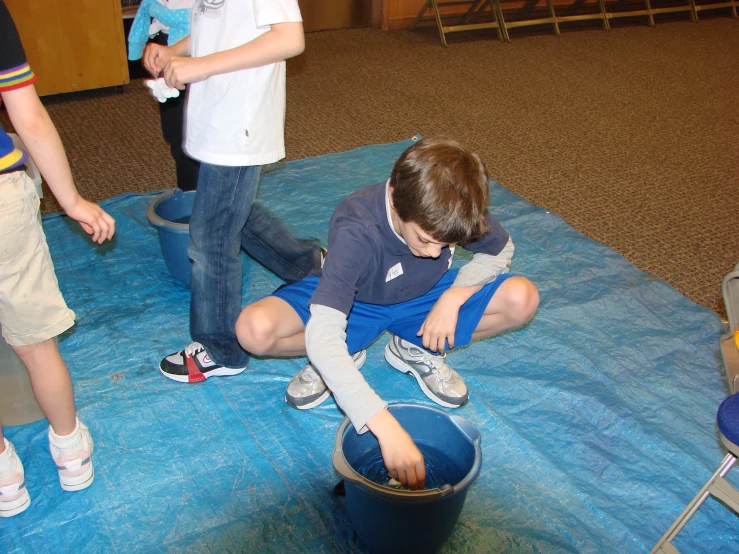 three s playing with a fire hydrant together