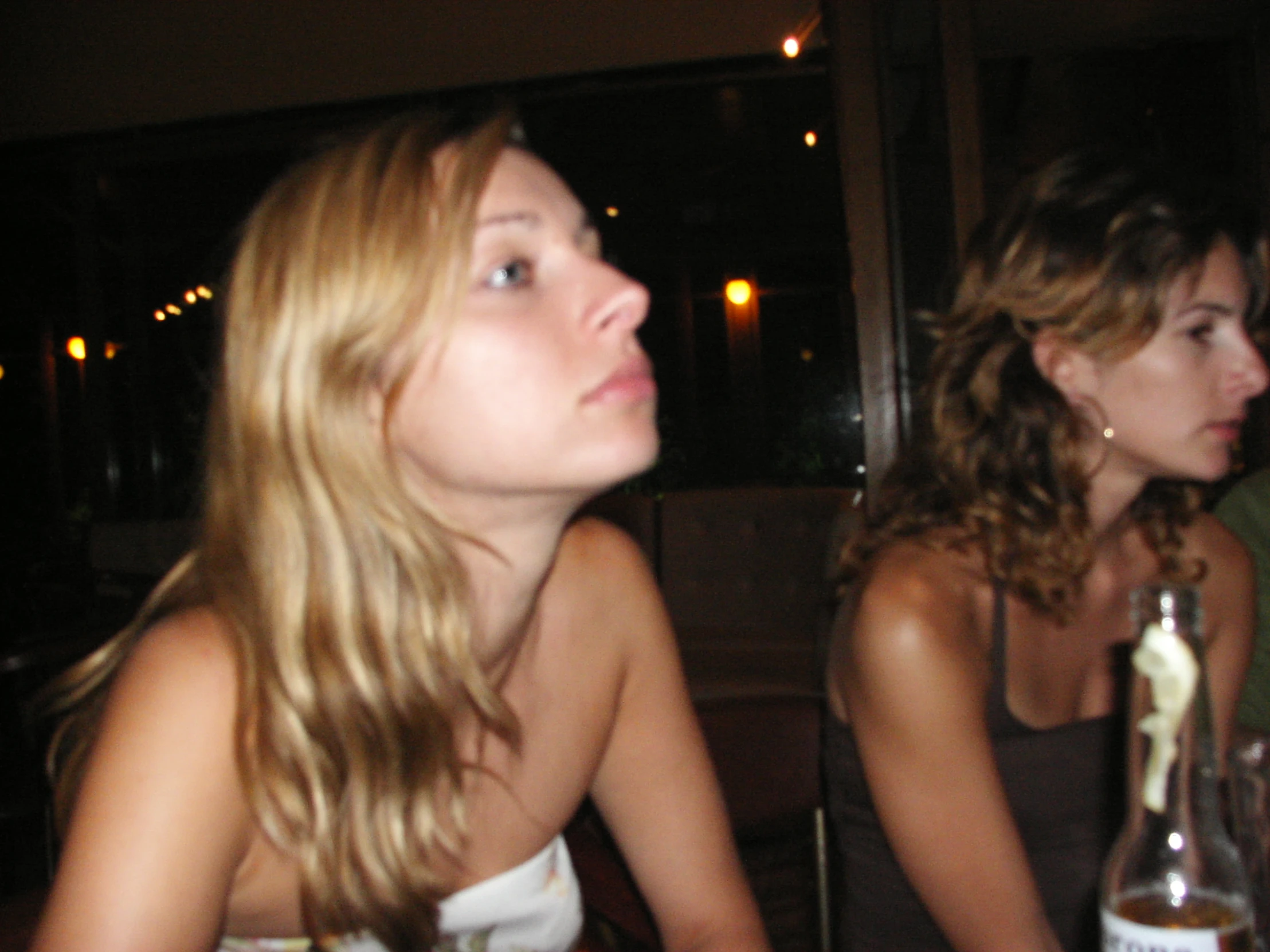 two pretty young women sitting at a dinner table