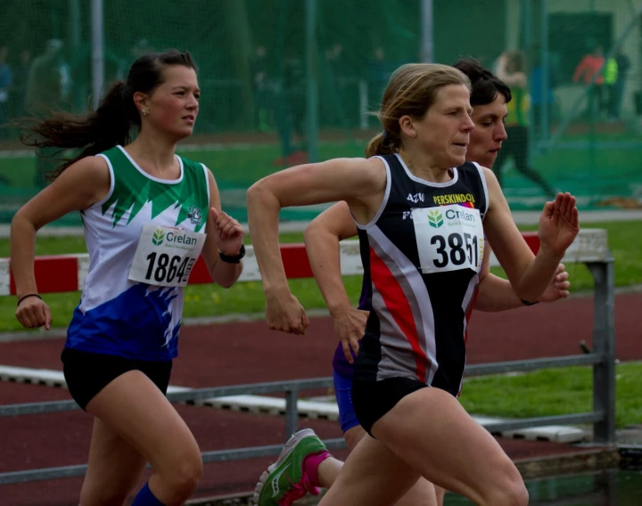 two people are running together in a race