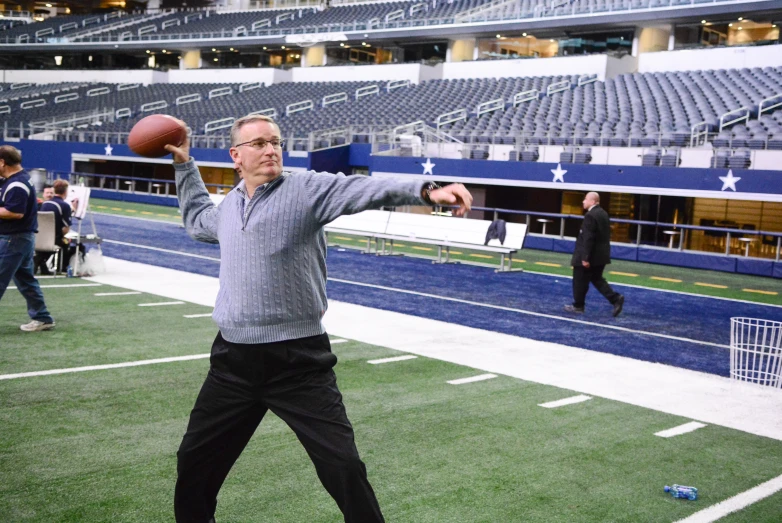 the man is throwing the ball during a football game