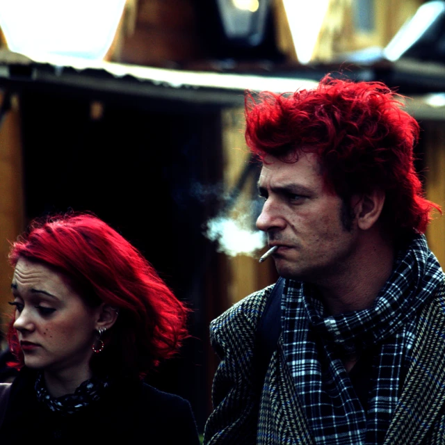 the man is smoking a cigarette with red hair