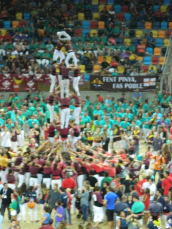 people standing in the middle of a crowd making o splits