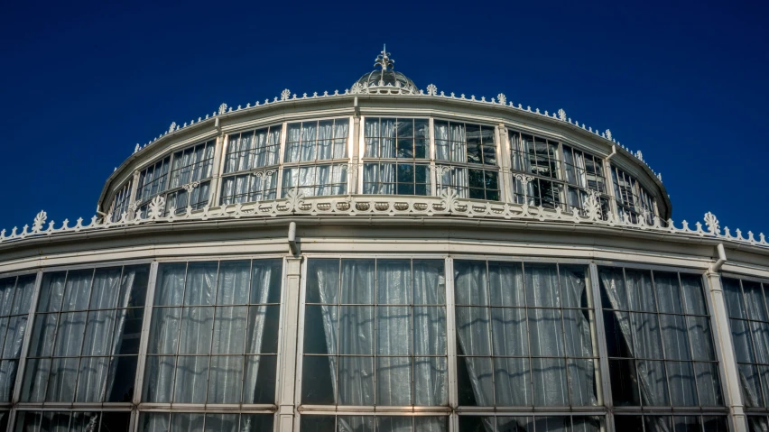 the building with large glass windows has a clock