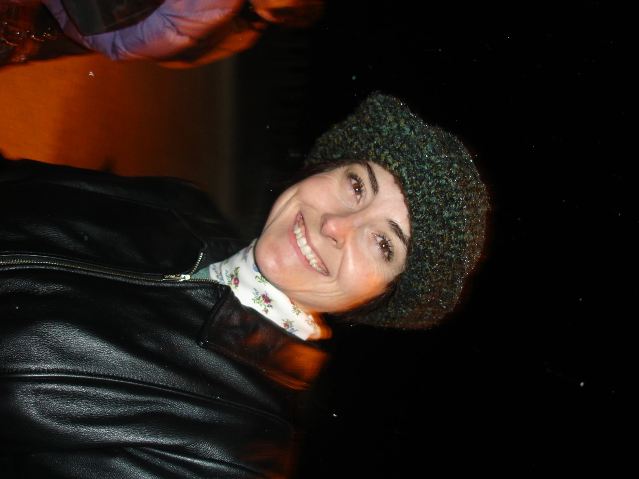 a young man wearing a black jacket and hat