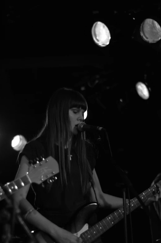 a black and white po of a person playing guitar