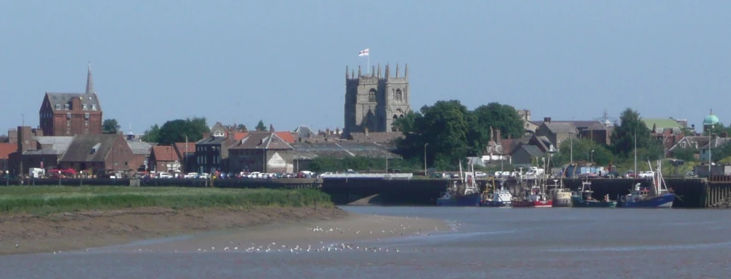 boats are docked in a harbor with the city in the background