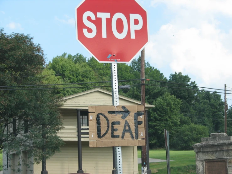 a sign with the word deal is hanging from a stop sign