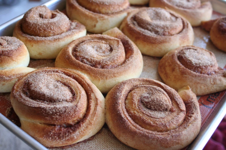 small pastries are being placed on a baking pan