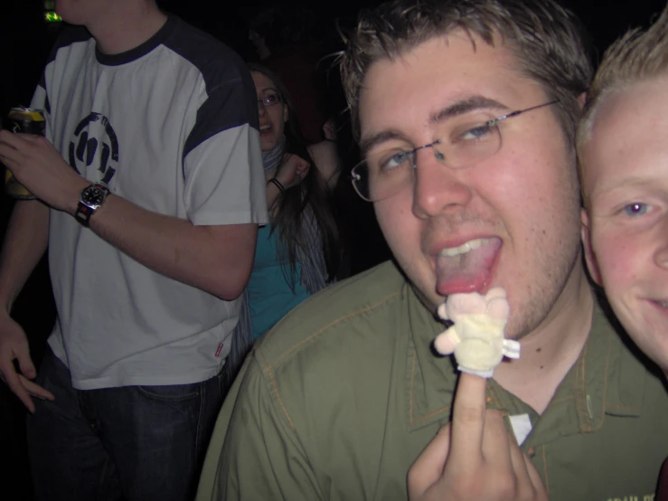 two young men who are eating some cake