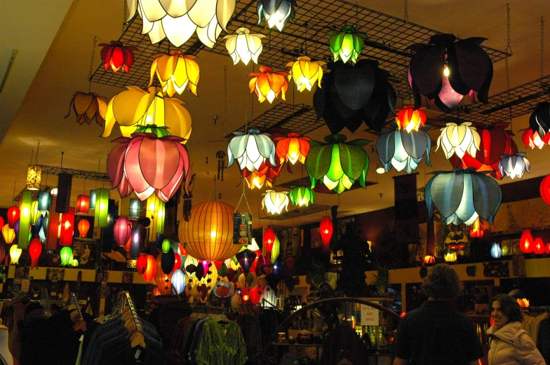 a number of lanterns in a room with people