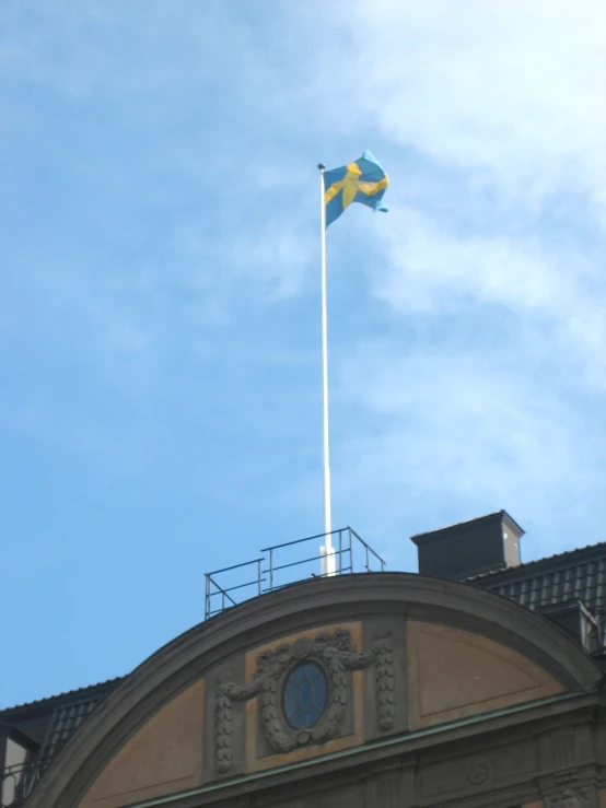 an architectural building has a flag on top