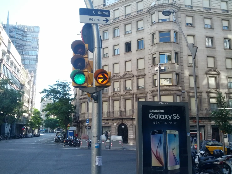 a green traffic light sitting next to a road