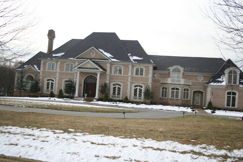 a large brown and white house with windows