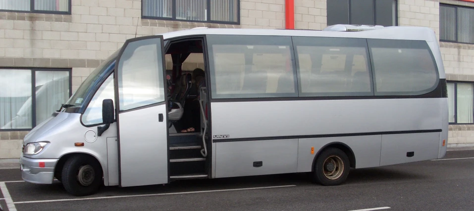 the large city bus is parked in the lot