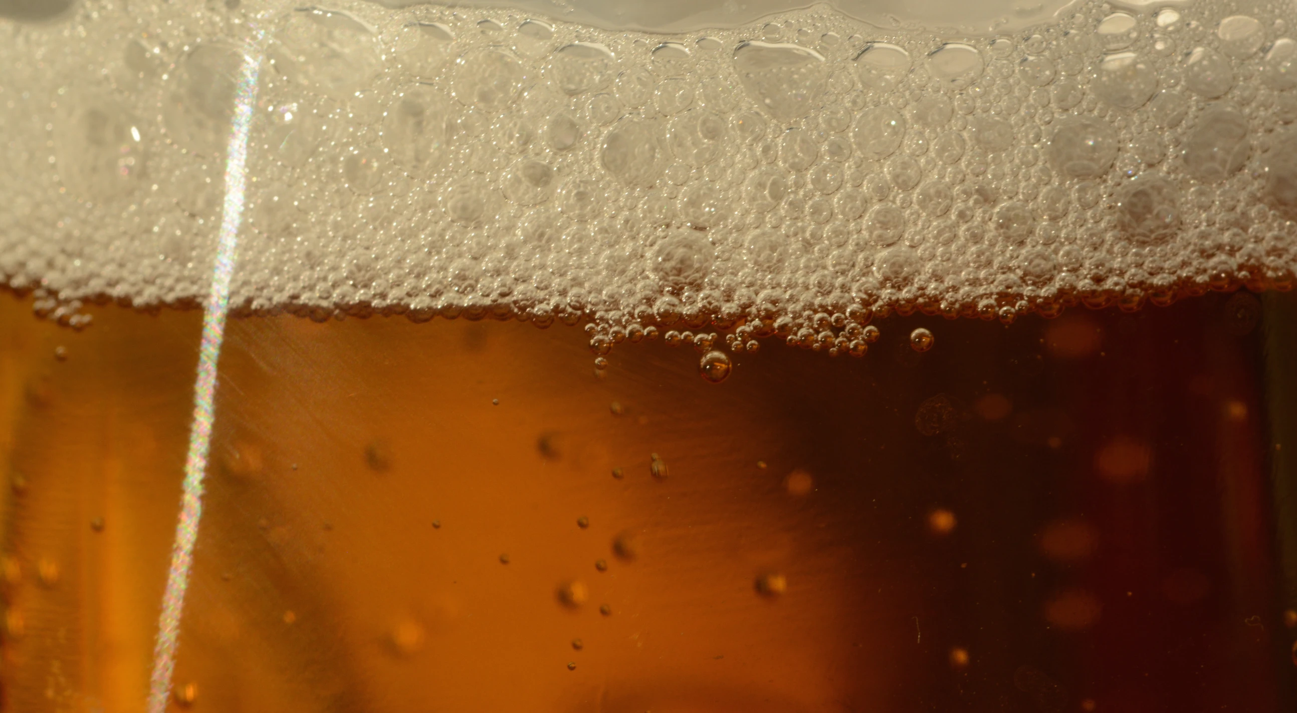 a close - up po of water bubbles over beer