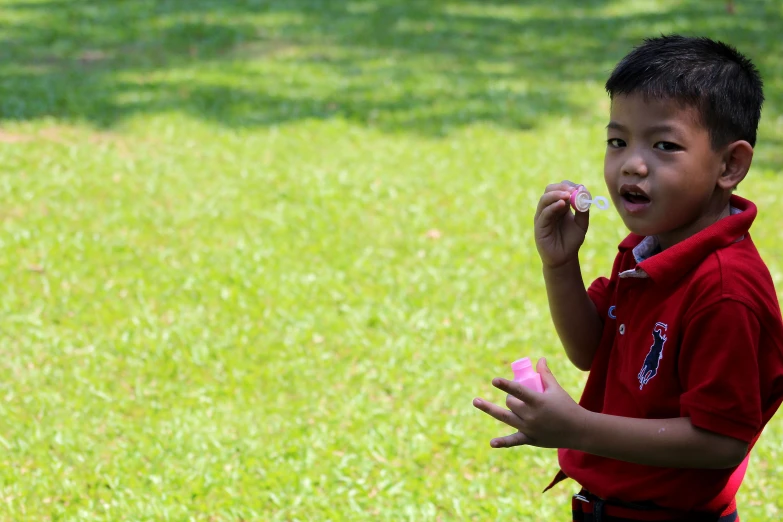  eating a snack in a grassy field