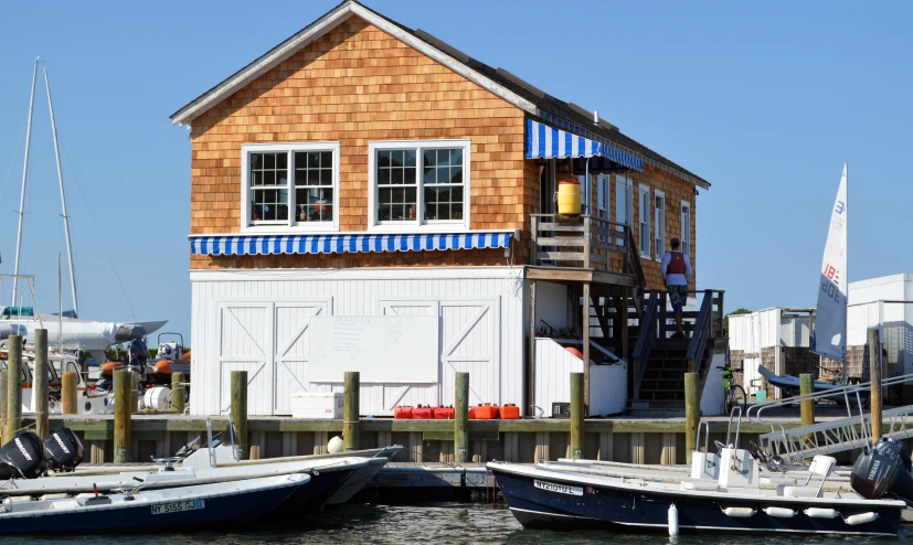 a house built into the water next to some boats