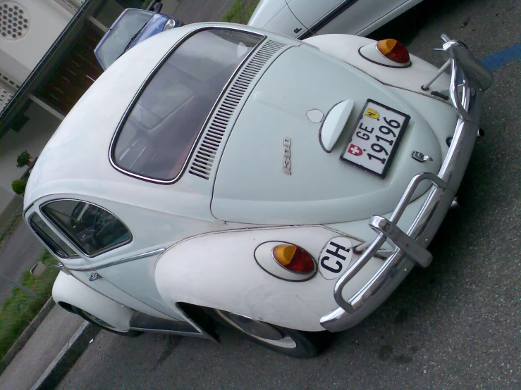 white car parked outside a building in a lot