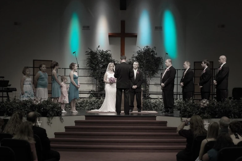 a bride and groom are standing on the steps