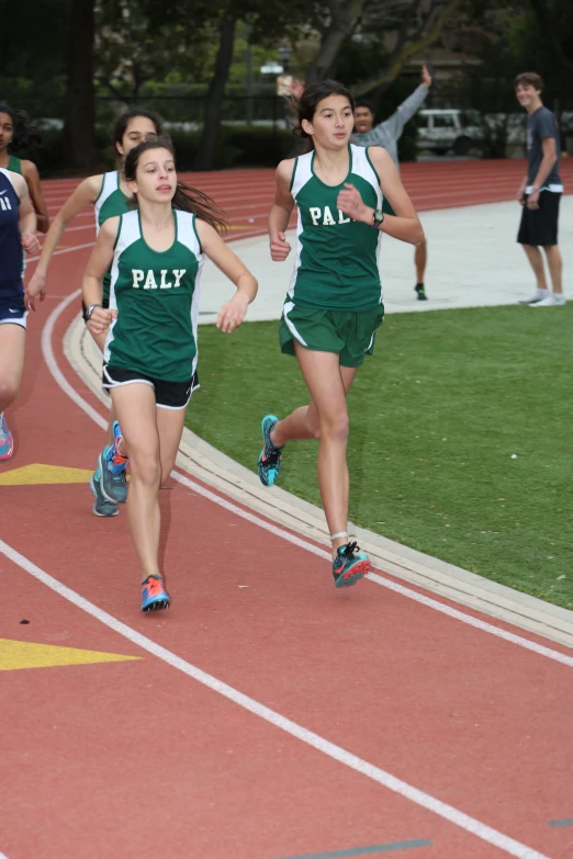 three girls running together in a track