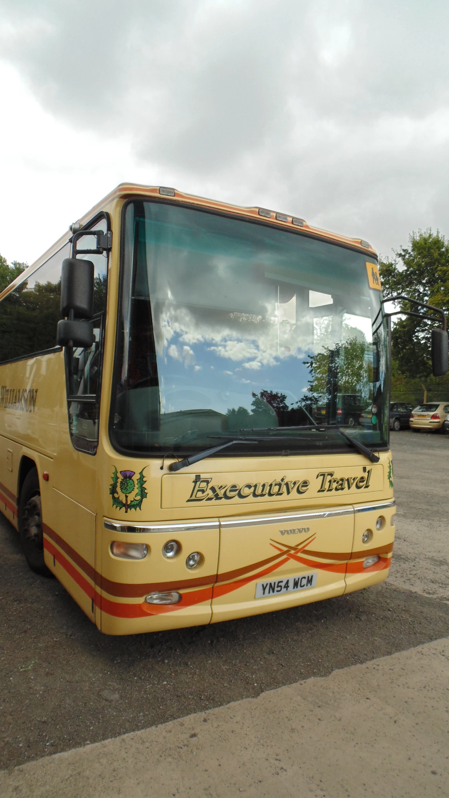 the yellow bus has decorative travel written on it