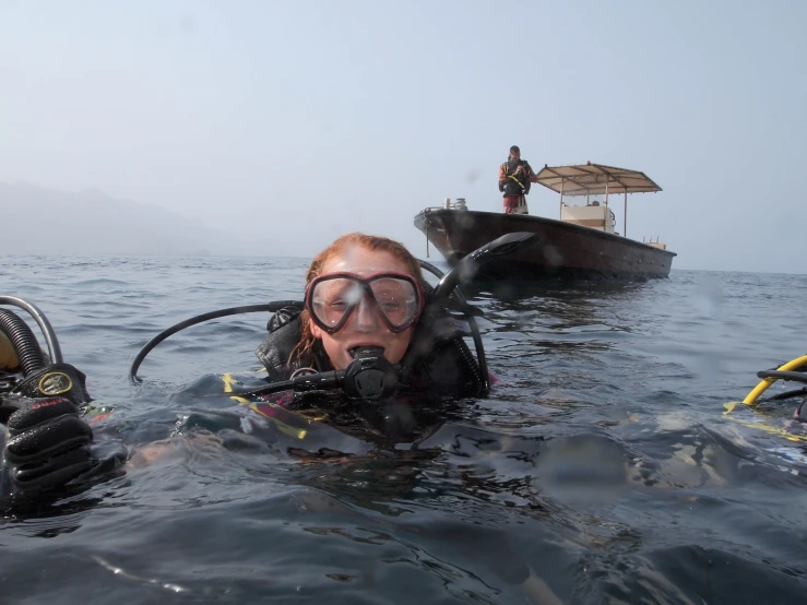 a person in water gear on top of a boat