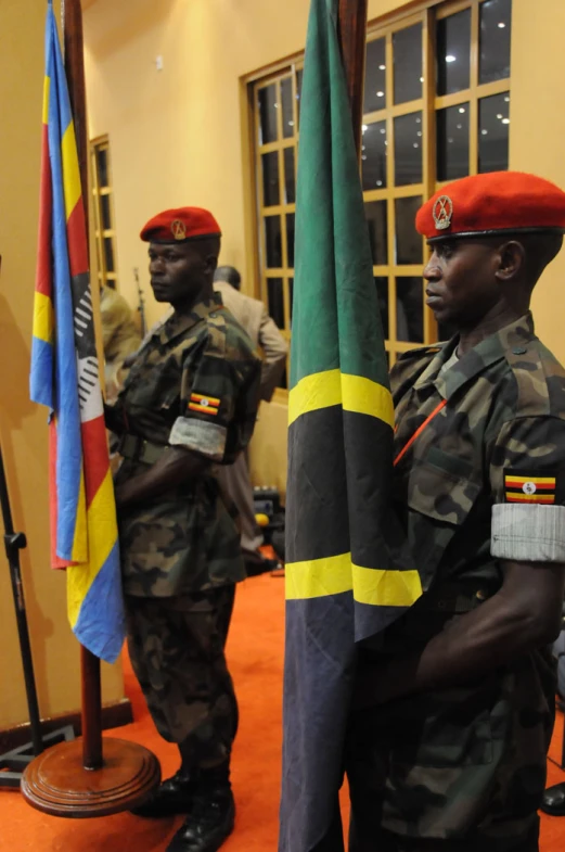 a couple of soldiers stand by flags