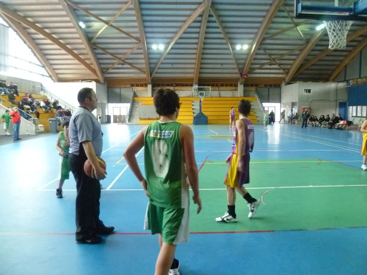 basketball players standing on the indoor court during a game