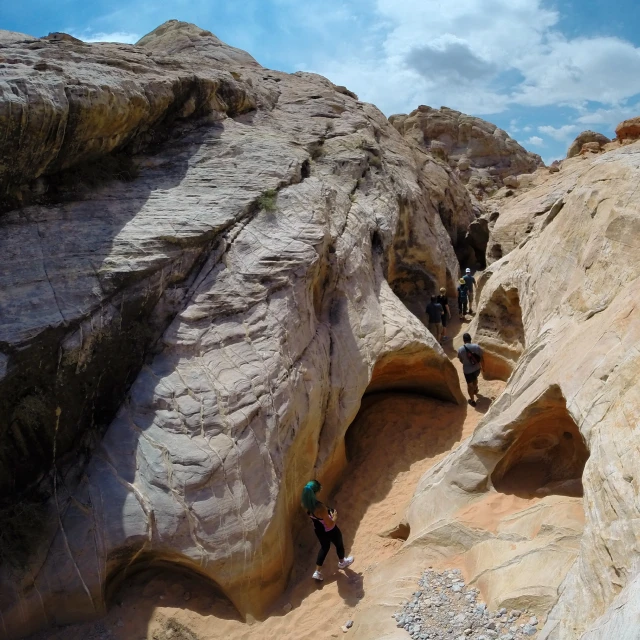 people climbing up and down a steep, rocky, canyon