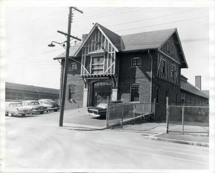 an old brick house with a car parked in front