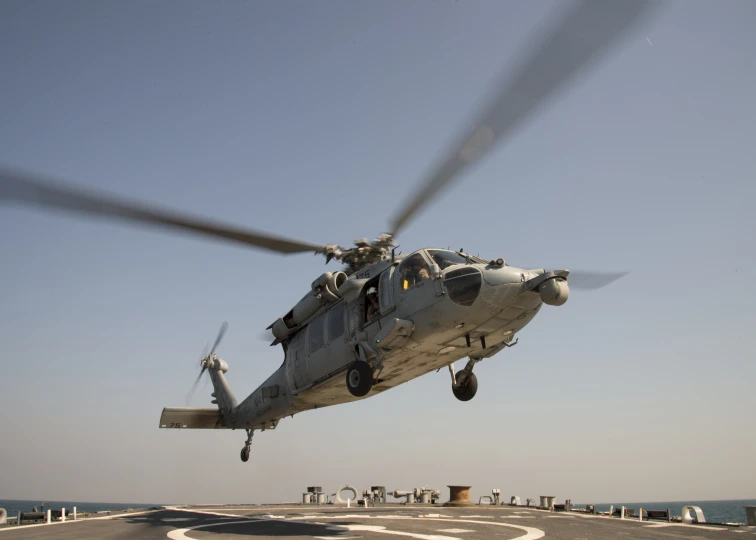 a large air craft is flying over an airport