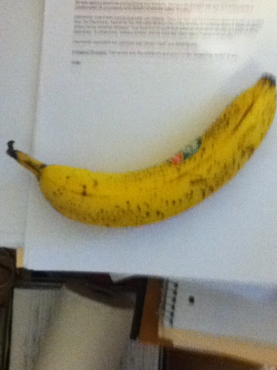 a yellow banana is sitting on top of a book