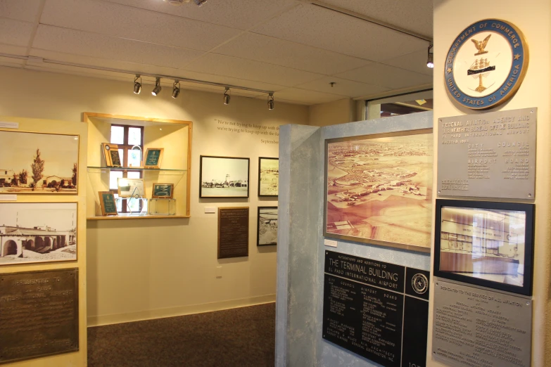 a clock and poster on a wall in a museum