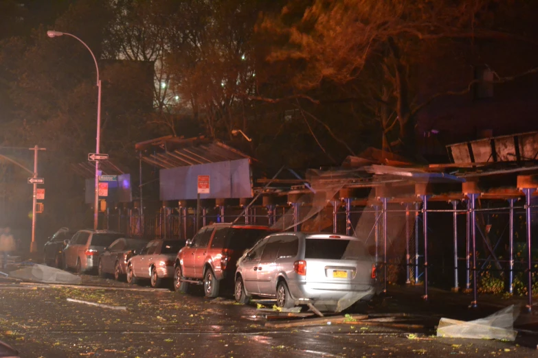 the cars are parked near the small business at night