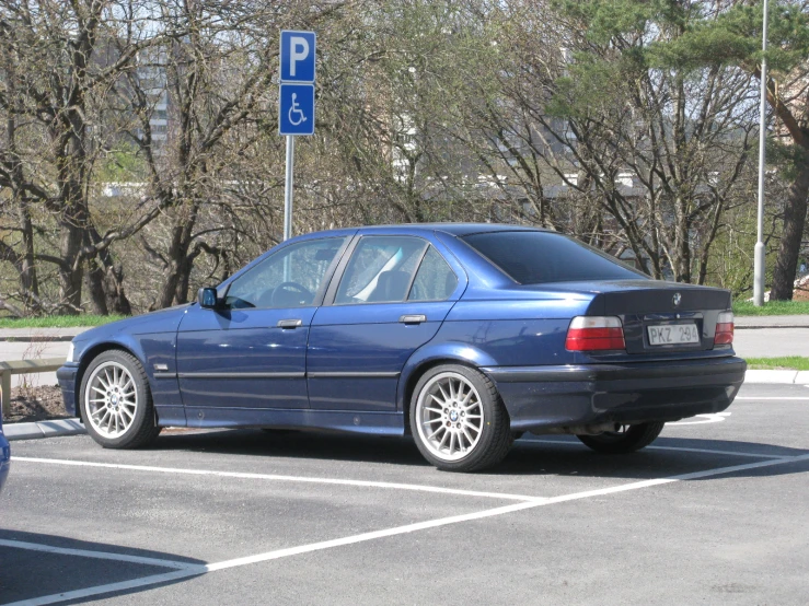 a blue bmw parked on the side of the street