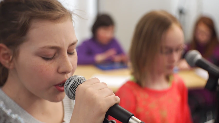 a woman standing next to a microphone