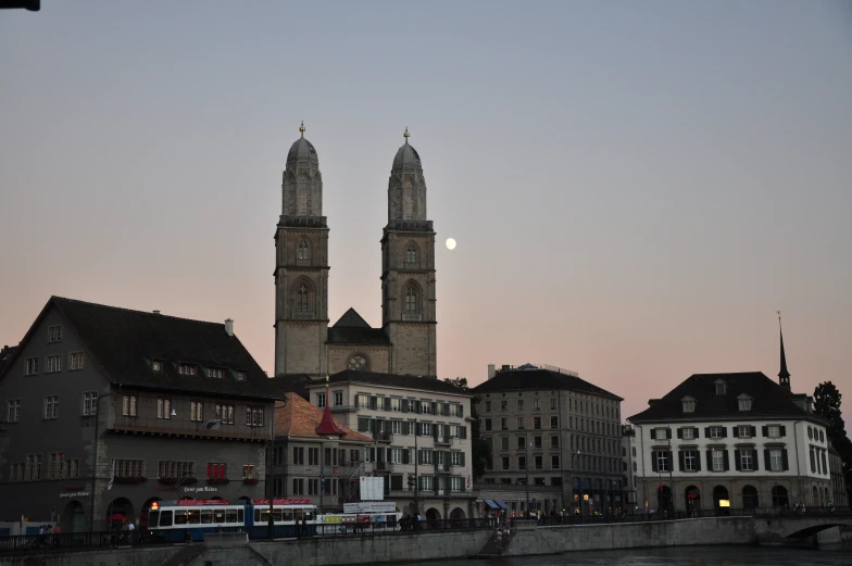 the tall buildings with towers that rise into the night sky