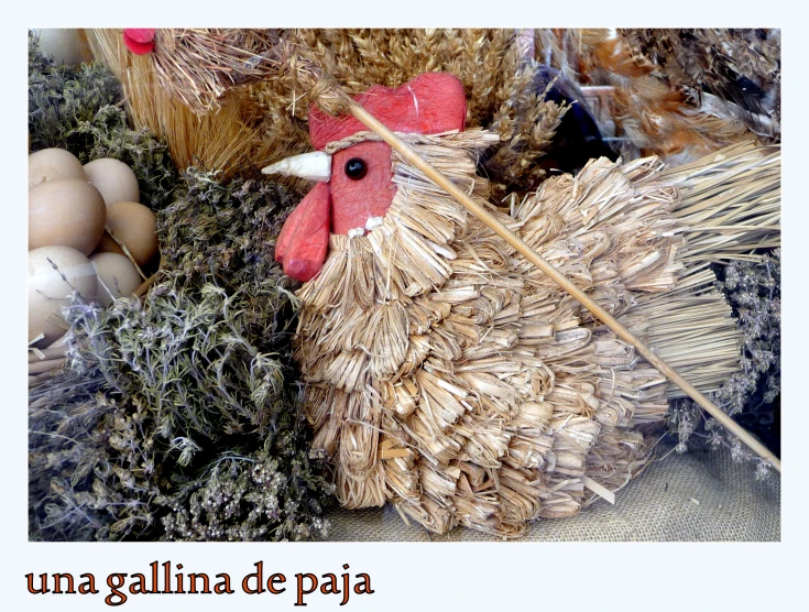a rooster made out of hay and grass