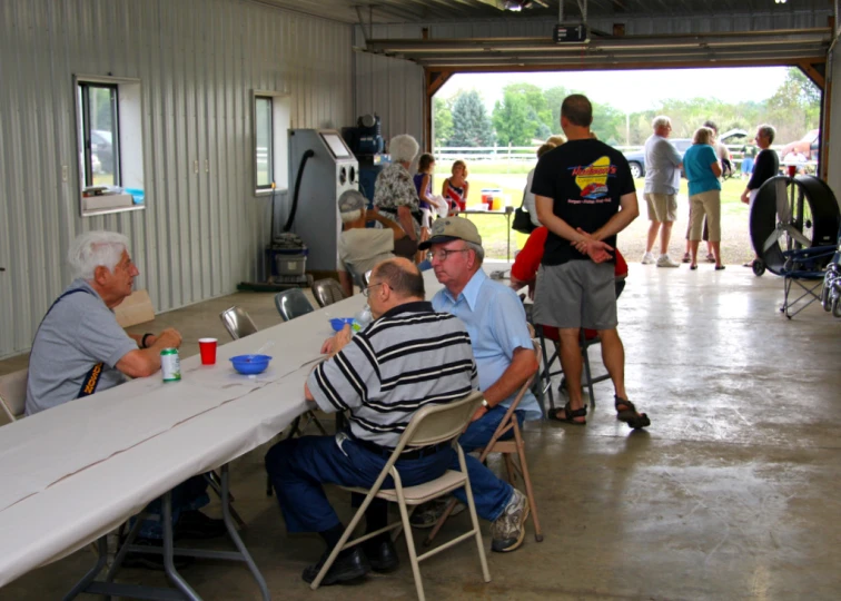 people sitting around tables talking at the same time