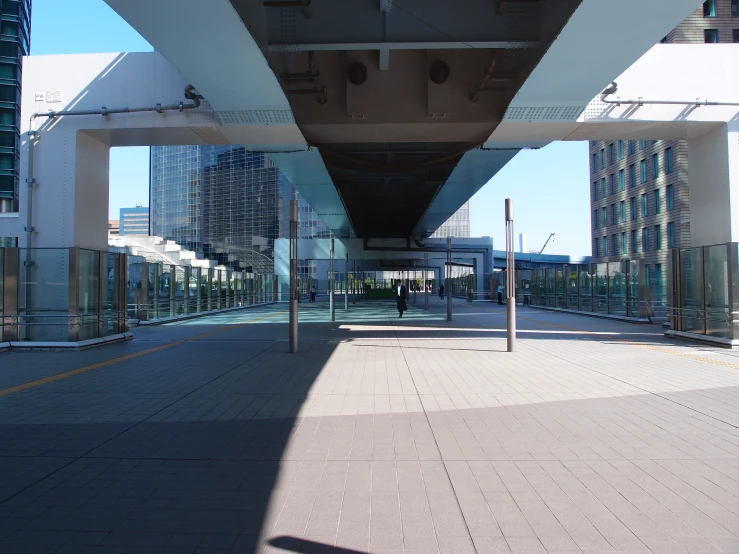 a pedestrian walking bridge over the width of a city street