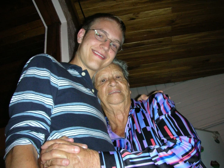 a man and woman hug while smiling together