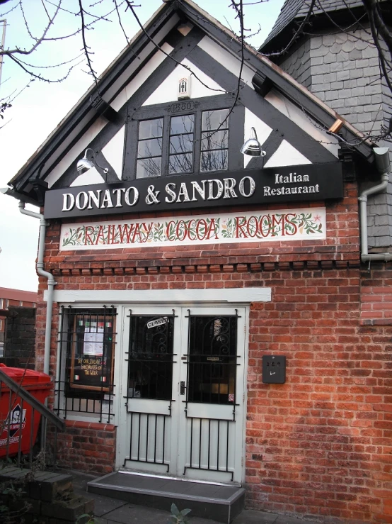 the door to an old brick building with an ornate sign