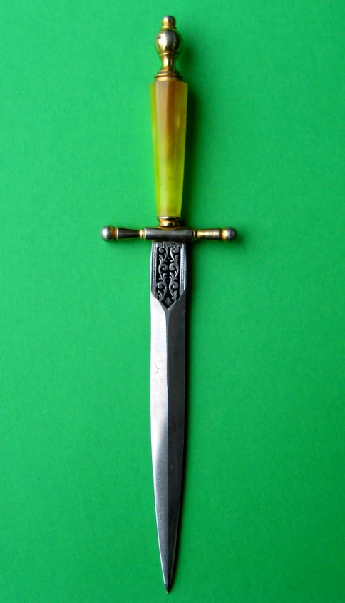 a large knife stuck into the side of a green surface