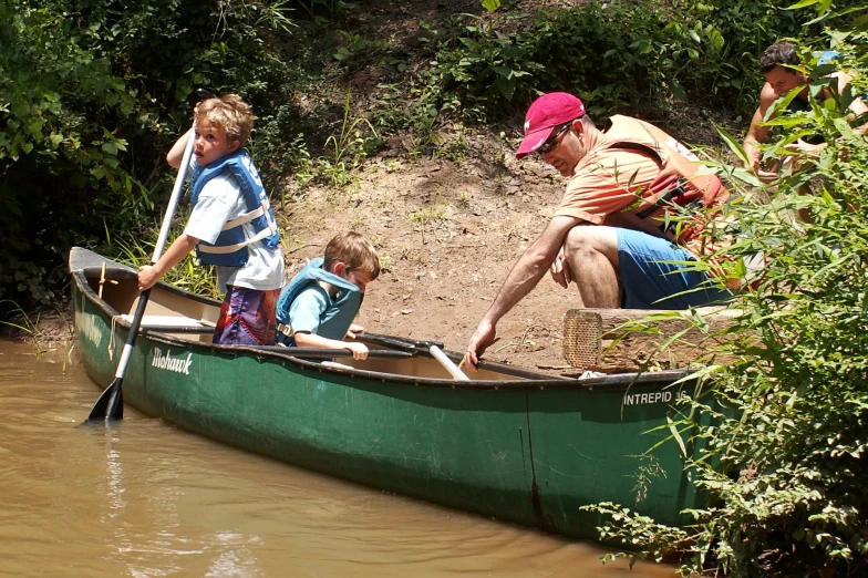 a family that is riding on a canoe in the water