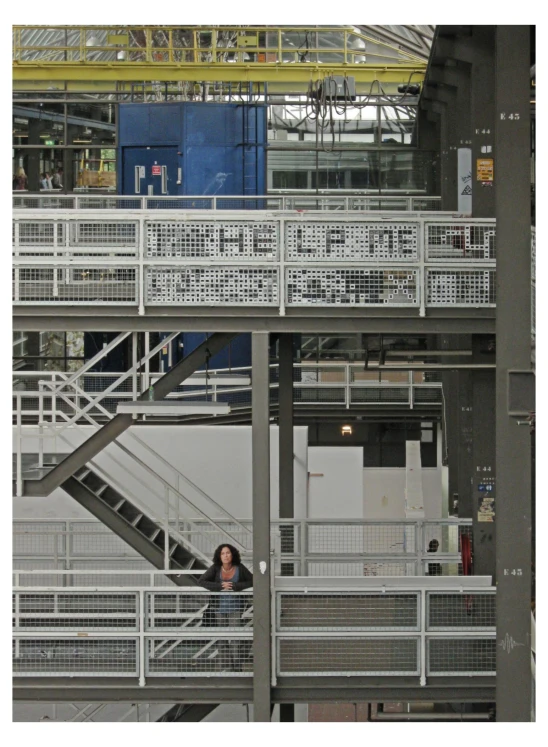 a white staircase in a building with people sitting in it