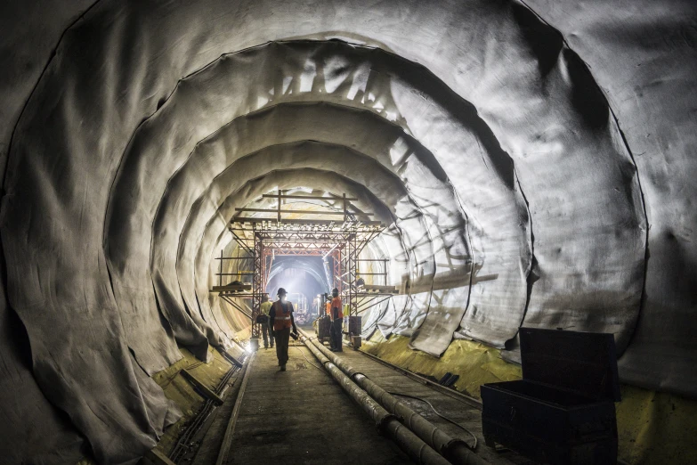 a very tall tunnel with several people inside