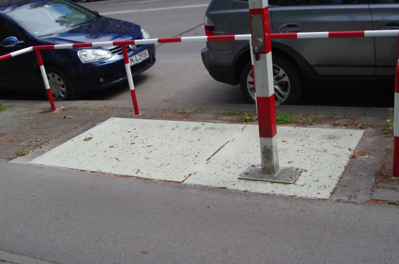 the car is parked behind the barriers on the street