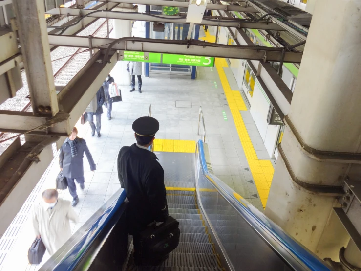 a man standing on an escalator at the airport