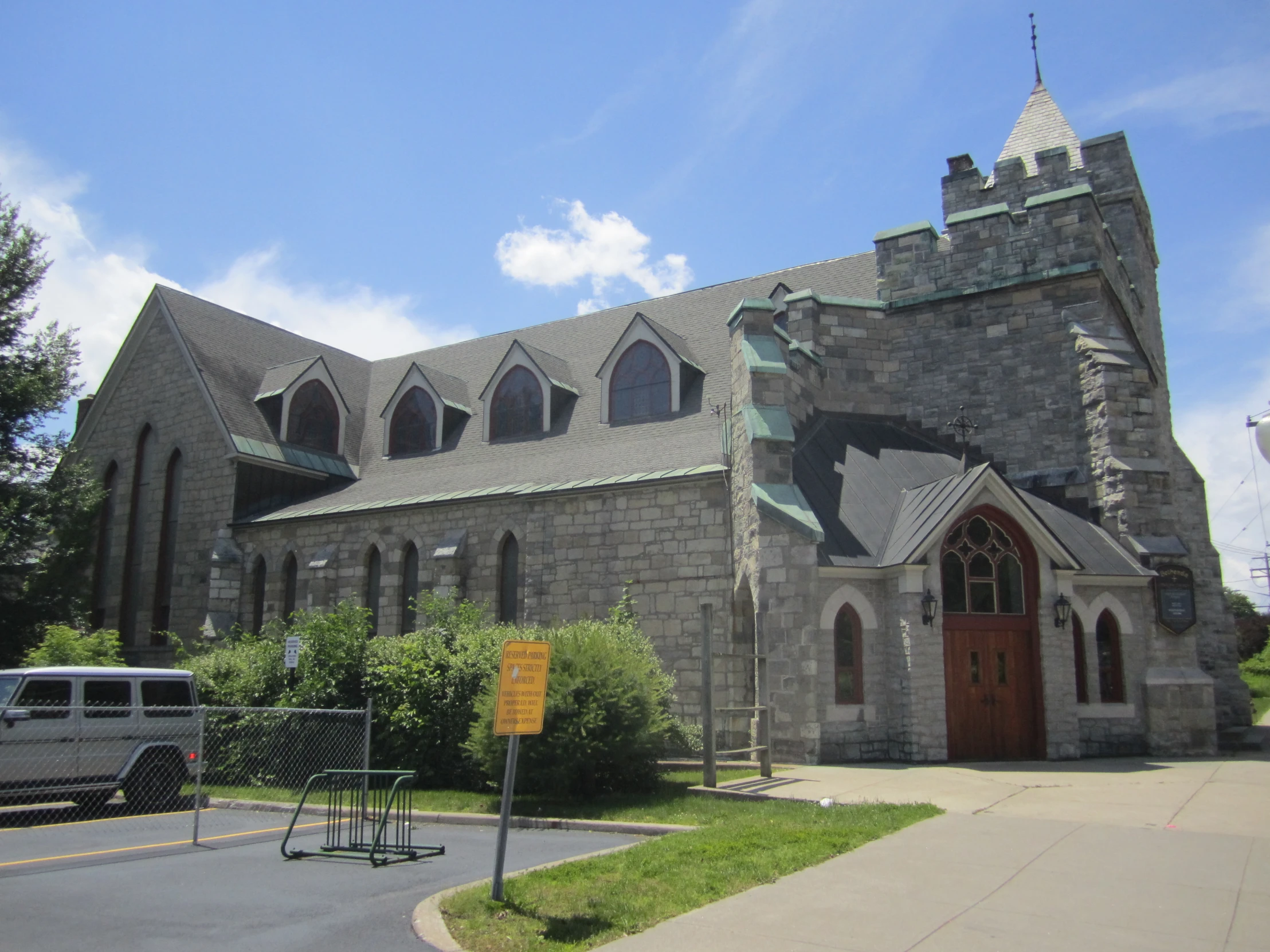 large grey church with a brick and glass front